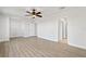 Spacious bedroom featuring modern flooring, ceiling fan, and multiple doorways at 658 Siren Wind Ln, Clearwater, FL 33756