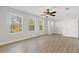 Bright, spacious bedroom featuring natural light from three windows and modern ceiling fan at 658 Siren Wind Ln, Clearwater, FL 33756