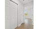 Bright hallway with wood-look flooring, and white doors leading to various rooms at 658 Siren Wind Ln, Clearwater, FL 33756