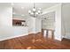 Open concept living and dining area with view to the kitchen and bedroom at 658 Siren Wind Ln, Clearwater, FL 33756