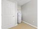 Utility room with water heater and storage space, featuring a neutral color scheme at 658 Siren Wind Ln, Clearwater, FL 33756