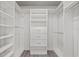 Well-organized walk-in closet featuring built-in shelving, drawers, and ample hanging space at 658 Siren Wind Ln, Clearwater, FL 33756