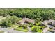 Aerial view of a home with lush landscaping, a pool, and a circular driveway at 663 Turnberry Ct, Tarpon Springs, FL 34688