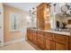 Bathroom featuring double vanities, granite countertops, and stylish lighting at 663 Turnberry Ct, Tarpon Springs, FL 34688