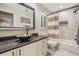 Bathroom with tiled shower, stylish vanity, and unique sink at 663 Turnberry Ct, Tarpon Springs, FL 34688