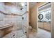 Tiled shower with a built-in bench and a view into the rest of the well appointed bathroom at 663 Turnberry Ct, Tarpon Springs, FL 34688