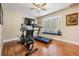 Bright bedroom featuring a home gym with a treadmill, bike, and bench seat at 663 Turnberry Ct, Tarpon Springs, FL 34688