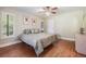 Cozy bedroom with wood floors, ceiling fan, shuttered window, and neutral walls at 663 Turnberry Ct, Tarpon Springs, FL 34688