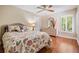 Bedroom showcasing hardwood floors, a decorative mirror, and shuttered windows at 663 Turnberry Ct, Tarpon Springs, FL 34688