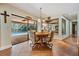 Breakfast nook with a round table, seating for four, views of the screened lanai and pool area at 663 Turnberry Ct, Tarpon Springs, FL 34688