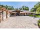 Beautiful exterior elevation with stone accents and spacious paver driveway at 663 Turnberry Ct, Tarpon Springs, FL 34688