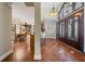 Inviting foyer with decorative glass doors, elegant chandelier, and tile flooring that seamlessly transitions into the adjacent dining area at 663 Turnberry Ct, Tarpon Springs, FL 34688