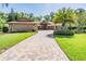 Charming home featuring a stone-accented exterior and well-manicured landscaping at 663 Turnberry Ct, Tarpon Springs, FL 34688