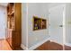 Hallway featuring hardwood floors, storage cabinets, and a niche for decor at 663 Turnberry Ct, Tarpon Springs, FL 34688