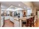 Modern kitchen with granite countertops, stainless steel appliances, a center island, breakfast bar, and ample cabinet space at 663 Turnberry Ct, Tarpon Springs, FL 34688