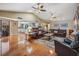 Expansive living room with access to the kitchen, and views of the stone fireplace and vaulted ceilings at 663 Turnberry Ct, Tarpon Springs, FL 34688