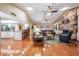 Well-lit open floorplan featuring a stone fireplace, direct access to the kitchen and multiple seating areas at 663 Turnberry Ct, Tarpon Springs, FL 34688