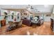 Open-concept layout with a living room featuring a stone fireplace, built-in shelving, and a casual dining area at 663 Turnberry Ct, Tarpon Springs, FL 34688