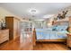 Bright and spacious main bedroom with wood floors and shutters on windows and doors at 663 Turnberry Ct, Tarpon Springs, FL 34688