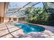 Covered pool area with a screened enclosure and ample seating at 663 Turnberry Ct, Tarpon Springs, FL 34688