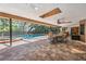 Screened-in outdoor pool area with a covered patio and ample seating at 663 Turnberry Ct, Tarpon Springs, FL 34688