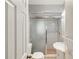 A well-lit bathroom with a glass-enclosed shower and pedestal sink at 7012 Ponderosa Dr, Tampa, FL 33637