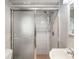 Bathroom featuring a tiled shower and a modern glass shower door at 7012 Ponderosa Dr, Tampa, FL 33637