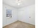 Bright bedroom with ceiling fan, closet, and natural light from a window at 7012 Ponderosa Dr, Tampa, FL 33637