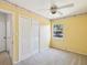 Cozy bedroom with a ceiling fan, and a closet offering storage space at 7012 Ponderosa Dr, Tampa, FL 33637