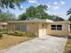 Charming single-story home with a well-maintained front yard and a classic yellow siding at 7012 Ponderosa Dr, Tampa, FL 33637