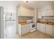 A quaint kitchen featuring white appliances, wood countertops, and ample cabinet space at 7012 Ponderosa Dr, Tampa, FL 33637