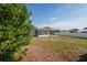Backyard view of home shows a covered patio and lots of yard at 7050 Merrick Ln, Spring Hill, FL 34606