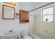 Well-lit bathroom featuring a classic vanity, toilet, and shower/tub combo at 7050 Merrick Ln, Spring Hill, FL 34606