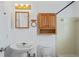 This cozy bathroom features warm lighting and white fixtures that provide a clean, minimalist design at 7050 Merrick Ln, Spring Hill, FL 34606