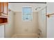 Bright bathroom with white tile, functional storage, and natural light creates a clean and inviting space at 7050 Merrick Ln, Spring Hill, FL 34606