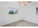 Bright and airy bedroom features large windows offering natural light and tile flooring throughout at 7050 Merrick Ln, Spring Hill, FL 34606