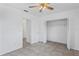 Spacious bedroom with tile floors, and open closet space for easy storage solutions at 7050 Merrick Ln, Spring Hill, FL 34606