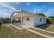 Home exterior shows covered patio and driveway with parking at 7050 Merrick Ln, Spring Hill, FL 34606