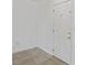 Clean hallway with neutral tile flooring and a white interior door at 7050 Merrick Ln, Spring Hill, FL 34606