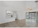 Bright living room featuring tile flooring, a ceiling fan, and sliding glass doors to the screened porch at 7050 Merrick Ln, Spring Hill, FL 34606