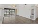 Open living space with tile flooring and sliding doors leading to a screened outdoor space at 7050 Merrick Ln, Spring Hill, FL 34606