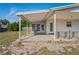 Covered patio is ready for entertaining with backyard access at 7050 Merrick Ln, Spring Hill, FL 34606