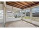 Enclosed sun room with wood ceiling, lots of light and view of backyard at 7050 Merrick Ln, Spring Hill, FL 34606