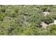 Aerial view of a home situated among lush trees, offering a sense of privacy and tranquility at 7233 Royal Oak Dr, Spring Hill, FL 34607