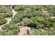 An aerial shot of a home with a pool surrounded by lush greenery and trees, creating a private oasis at 7233 Royal Oak Dr, Spring Hill, FL 34607
