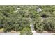 Aerial view showcases the property nestled among mature trees, offering privacy and a serene setting in a desirable neighborhood at 7233 Royal Oak Dr, Spring Hill, FL 34607