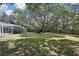 The home features a huge, fenced in back yard and pool with mature landscaping and trees at 7233 Royal Oak Dr, Spring Hill, FL 34607