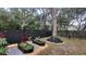 Inviting backyard with a modern raised garden, elegant fence, and picturesque landscaping, creating a serene outdoor haven at 7233 Royal Oak Dr, Spring Hill, FL 34607