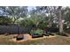 A charming backyard featuring a modern raised garden bed with an elegant black fence and thoughtful landscaping at 7233 Royal Oak Dr, Spring Hill, FL 34607