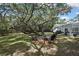 Inviting backyard with an outdoor seating area and lush landscaping, perfect for relaxation and entertainment by the screened pool at 7233 Royal Oak Dr, Spring Hill, FL 34607